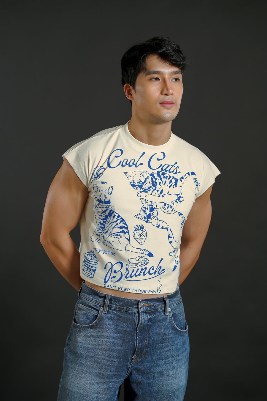 Man wearing a t-shirt with graphic design and text against a dark background